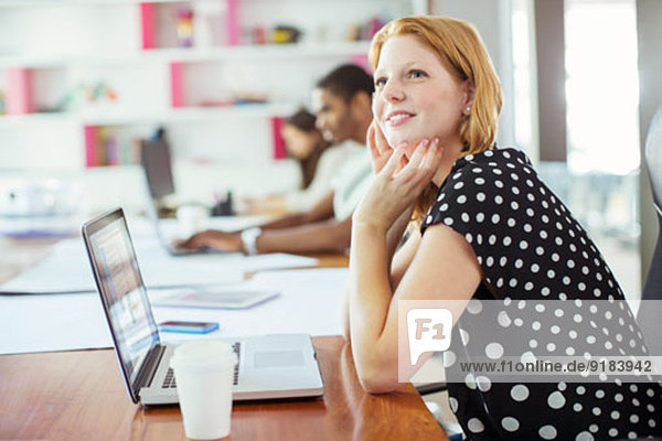 Woman working at conference table in office