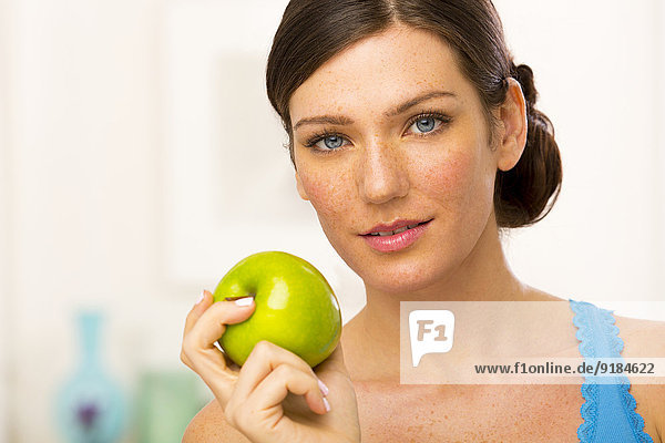 Caucasian woman holding apple