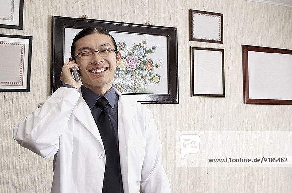 Mixed race doctor smiling in office