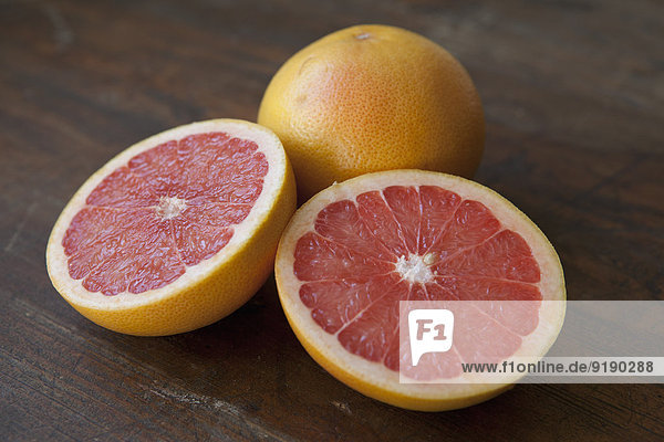 Close-up of pink grapefruits on table