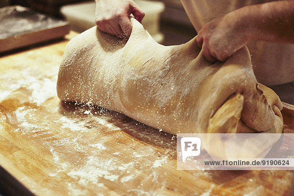 Cropped image of baker kneading dough