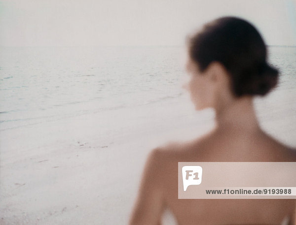 Junge Frau am Strand  Blick auf die Aussicht