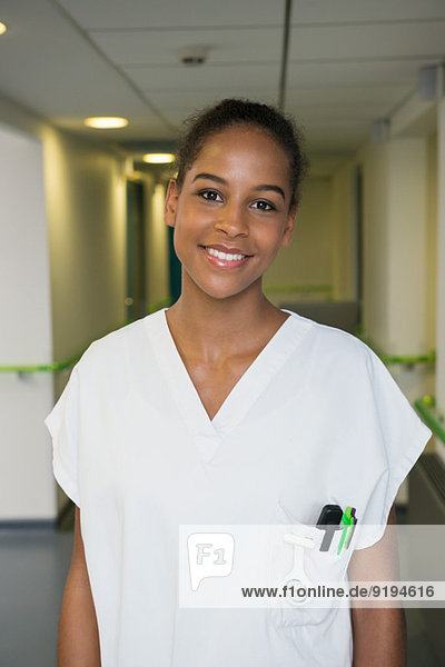 Portrait of a female nurse smiling in hospital corridor