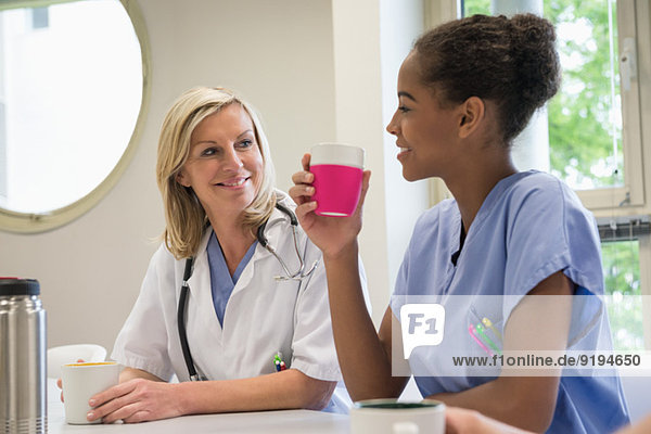 Ärztin und Krankenschwester bei einer Tasse Kaffee in der Krankenhauskantine