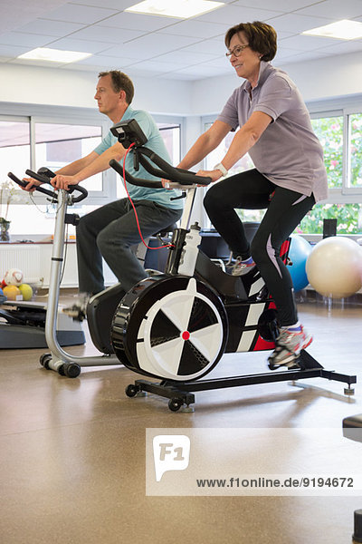 Man and woman in a spinning class at the gym