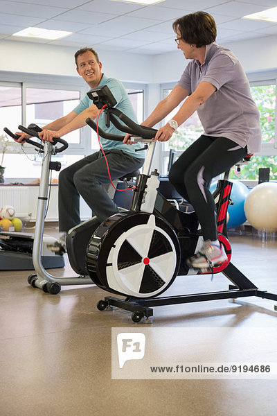 Man and woman in a spinning class at the gym