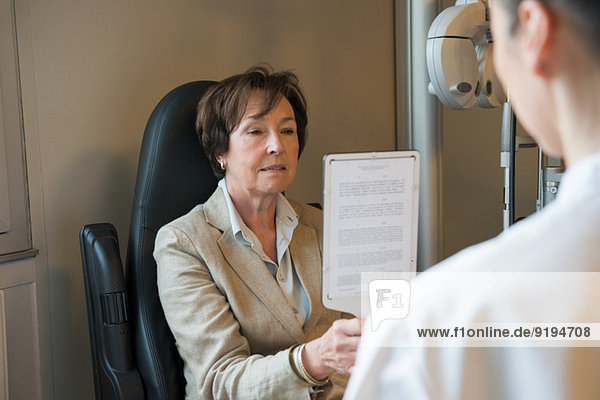 Female patient having eye examination in an optometrist clinic
