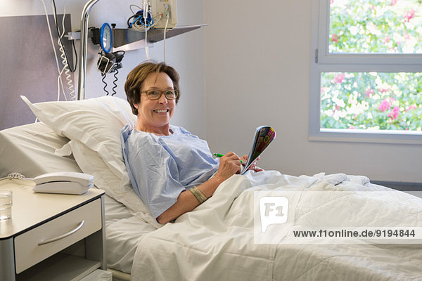 Frau lächelt auf Krankenhausbett