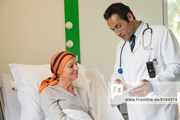 Doctor showing medical report to a patient