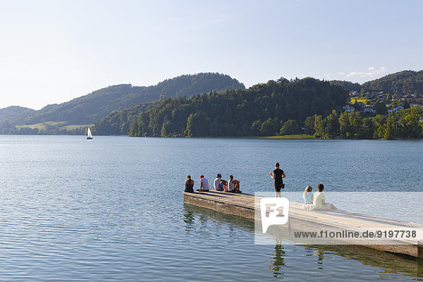 People on a jetty  Fuschlsee lake  Fuschl am See  Salzkammergut  Salzburg state  Salzburg State  Austria