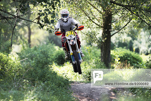 Young Man Riding Motocross Bike in Italian Countryside