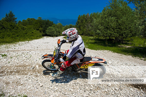 Young Man Riding Motocross Bike in Italian Countryside