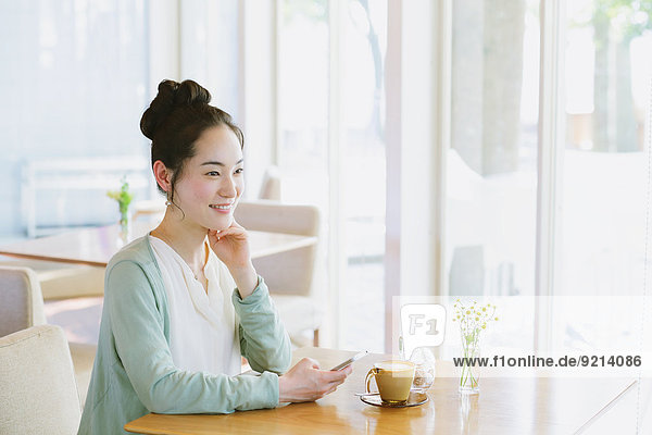 Japanese woman relaxing in a cafe