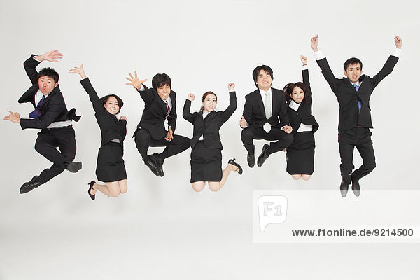 Japanese business people jumping