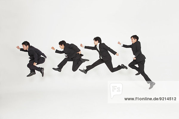Japanese businessmen jumping