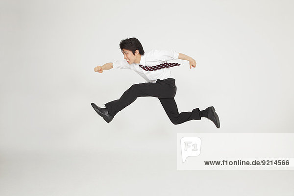 Japanese businessman running in mid-air