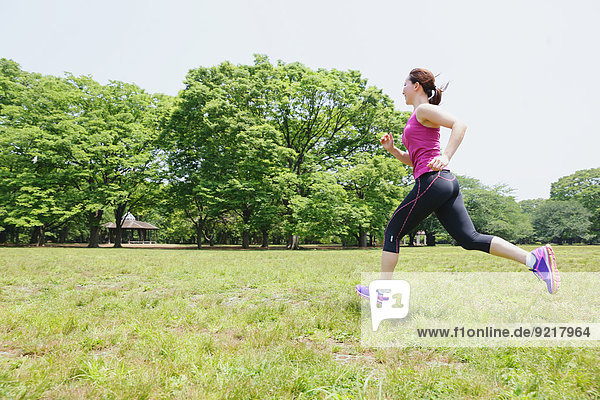 Young Japanese girl running in the park