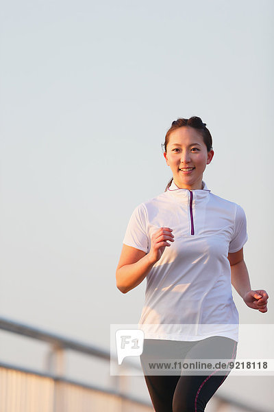 Young Japanese girl jogging
