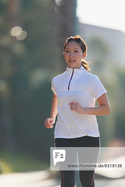 Young Japanese girl jogging