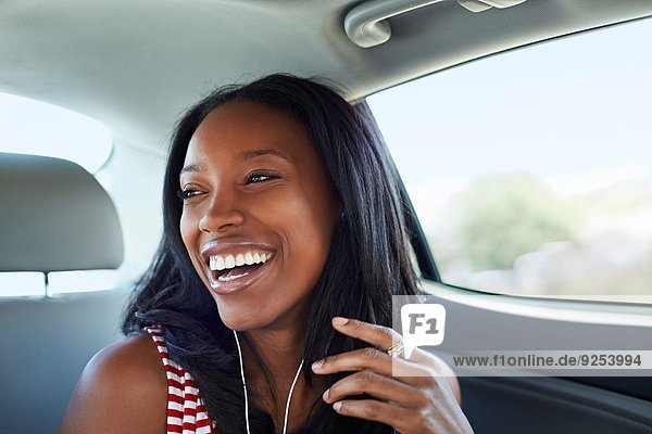 Young woman laughing car backseat