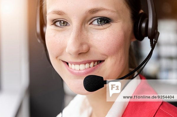 Close up of young businesswoman using telephone headset