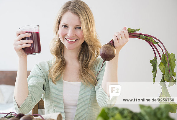 Woman holding beetroot and juice