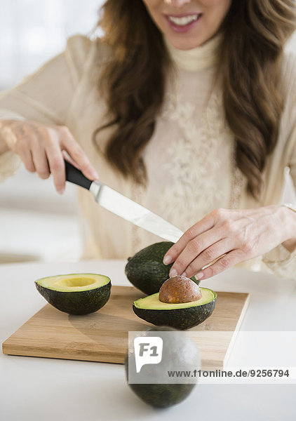 Woman cutting avocados