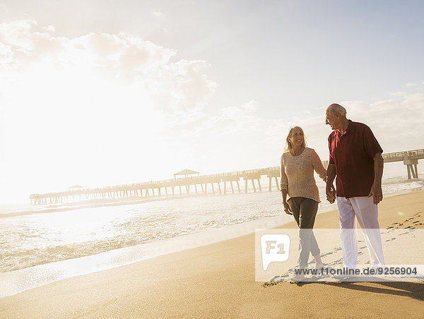 Senior couple walking on beach