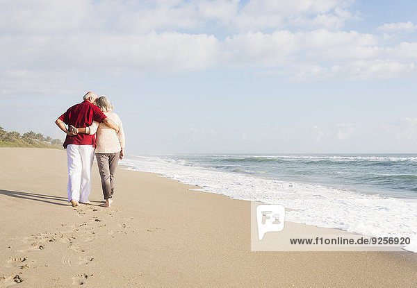 Senior couple walking on beach