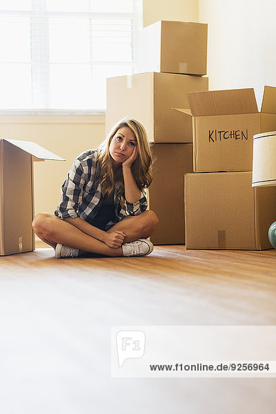 Young woman during moving into new house