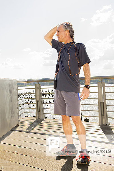 Caucasian man standing on wooden deck