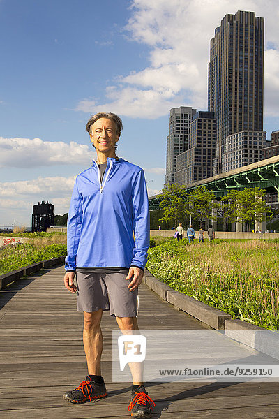 Caucasian man standing in urban park