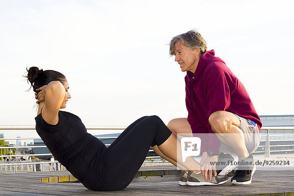 Couple exercising in waterfront park