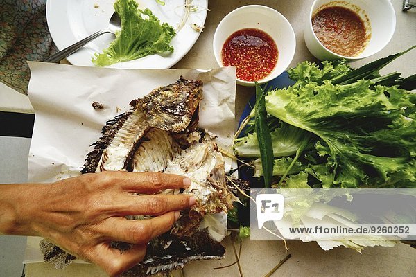 Grilled tilapia with lettuce and sauces (Thailand)