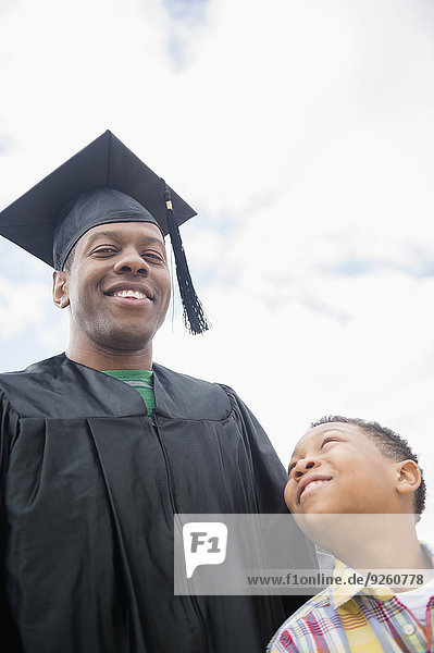Graduating father smiling with son