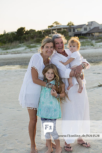 Caucasian family smiling on beach
