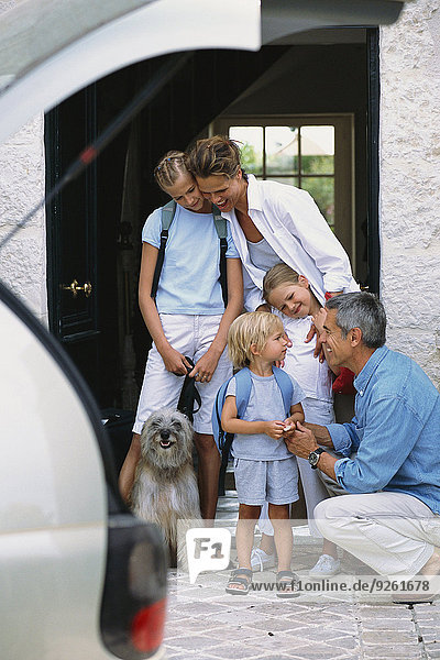 Caucasian family standing in doorway