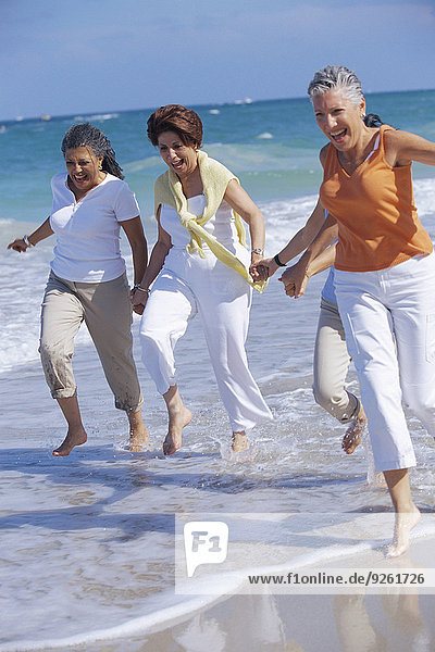Senior women running on beach