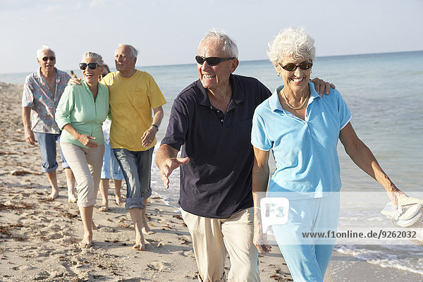 Senior couples walking on beach