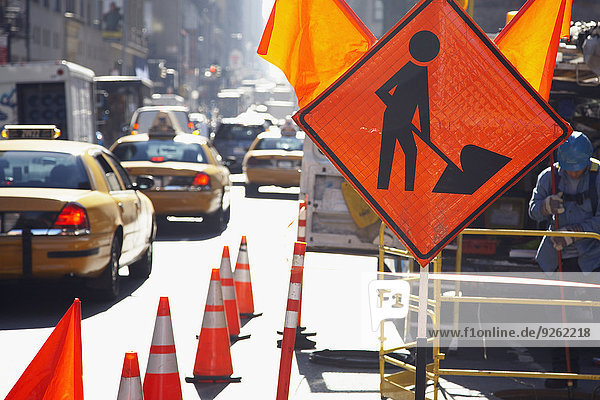 Traffic cones and sign on city street