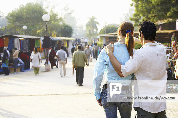 Couple walking in outdoor market