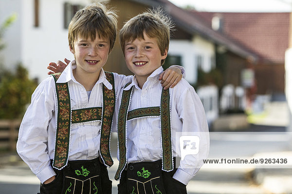 Germany  Murnau  Twin brothers wearing traditional costumes