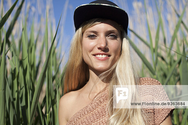 Portrait of smiling young woman wearing baseball cap