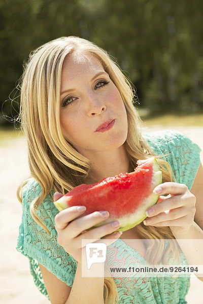 Porträt einer jungen Frau beim Essen einer Wassermelone
