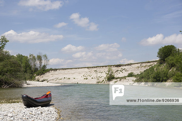 Germany  Bavaria  little rafting boat lying on rocky beach at waterside of Isar River