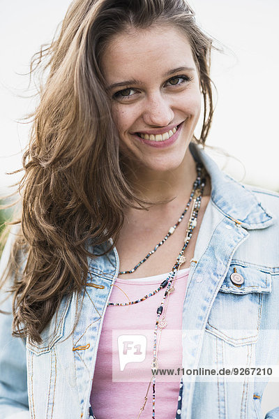 Portrait of smiling teenage girl wearing jeans jacket