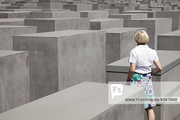 Germany  Berlin  Holocaust Memorial  Mature woman between steles