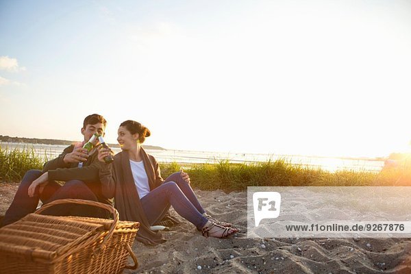 Young couple picnicing on Bournemouth beach  Dorset  UK