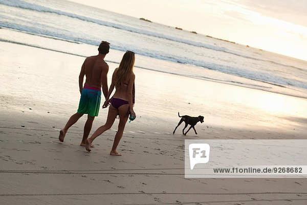 Couple strolling hand in hand on beach  Nosara  Guanacaste  Costa Rica