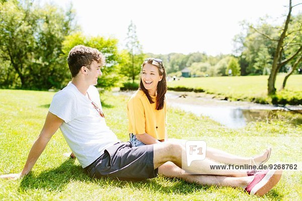 Couple sitting on grass in the park